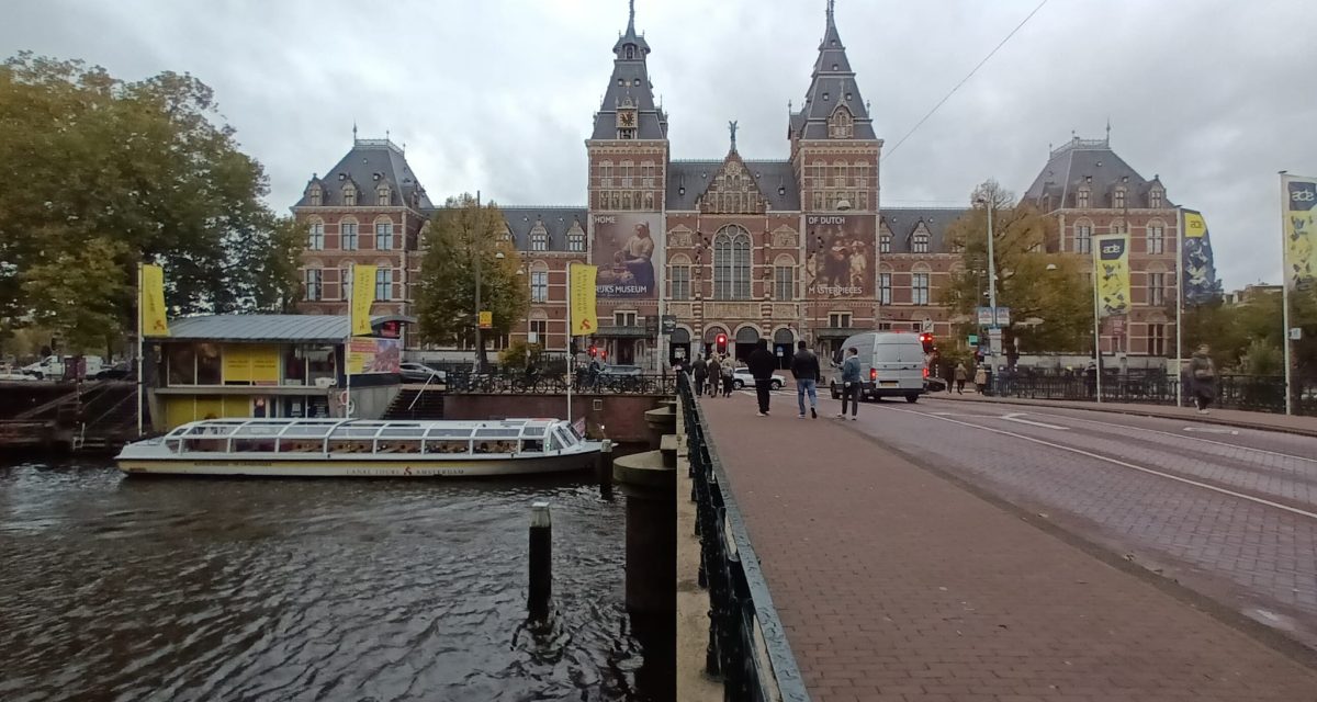 The Rijksmuseum’s historic façade beside Amsterdam’s waterways.