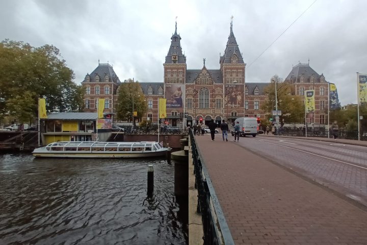 The Rijksmuseum’s historic façade beside Amsterdam’s waterways.