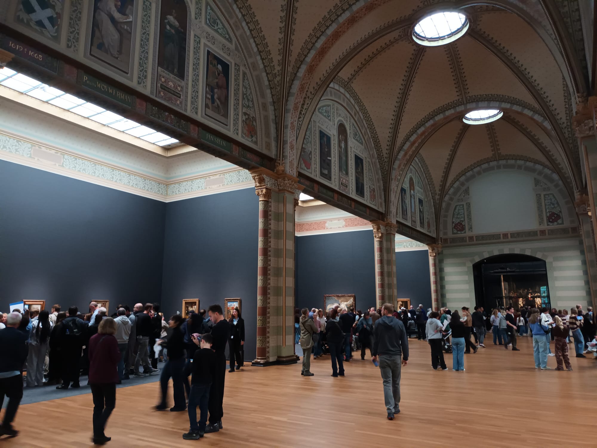 Visitors gather beneath the museum’s richly decorated vaulted ceilings